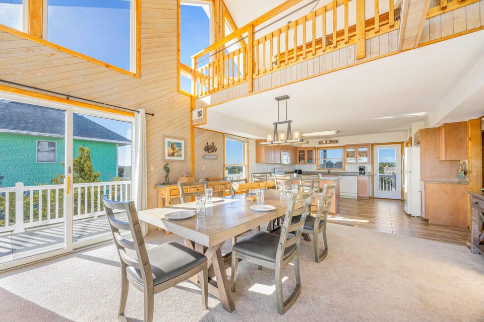 Gather around your spacious dining table where memories are made, with natural light streaming through expansive windows and your fully equipped kitchen just steps away.