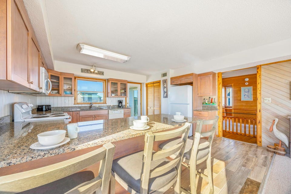 Your spacious kitchen features granite counters, modern appliances, and a breakfast bar where you can enjoy morning coffee together.