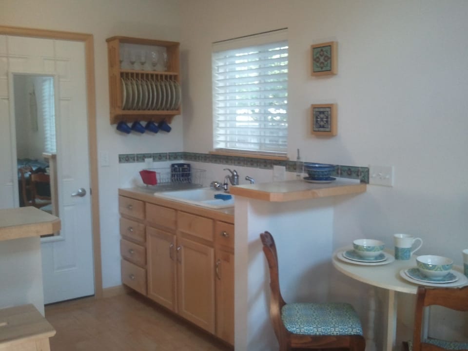 Quaint, cottage kitchen with hand-painted tiles.