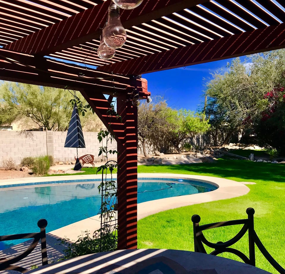 Cozy covered patio seating by the pool! Great for dining out or a cocktail!
