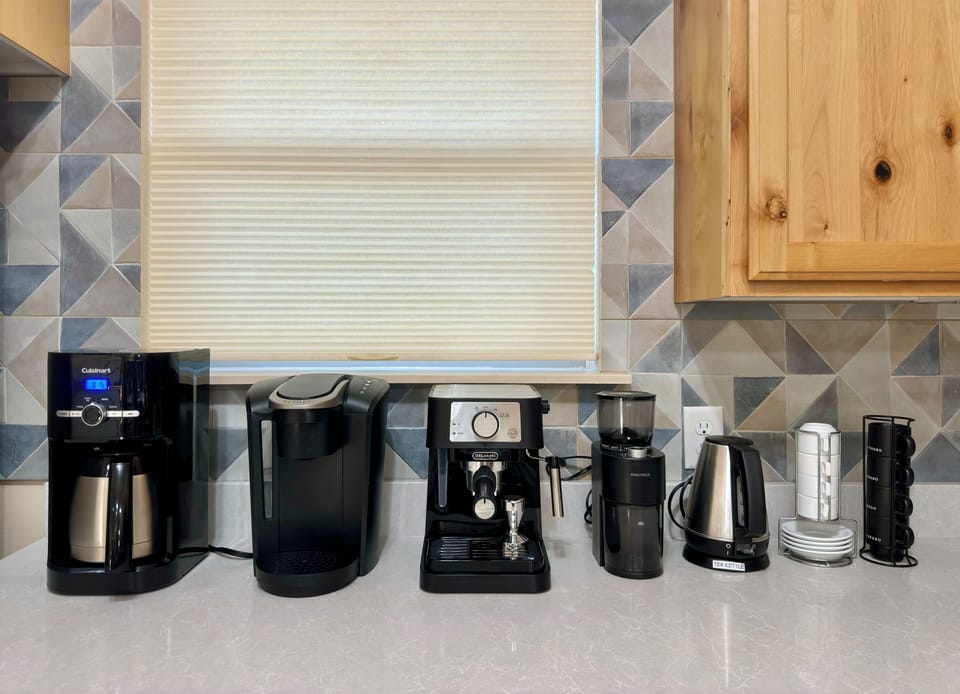 Coffee station: coffeemaker, espresso machine, Keurig, & grinder.