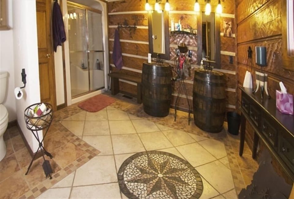 Cowgirl, cowboy bath with shower and authenic, whisky barrel sinks.