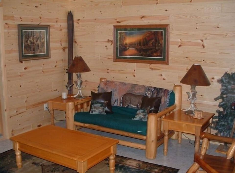 Family room w/television leads out to patio overlooking creek