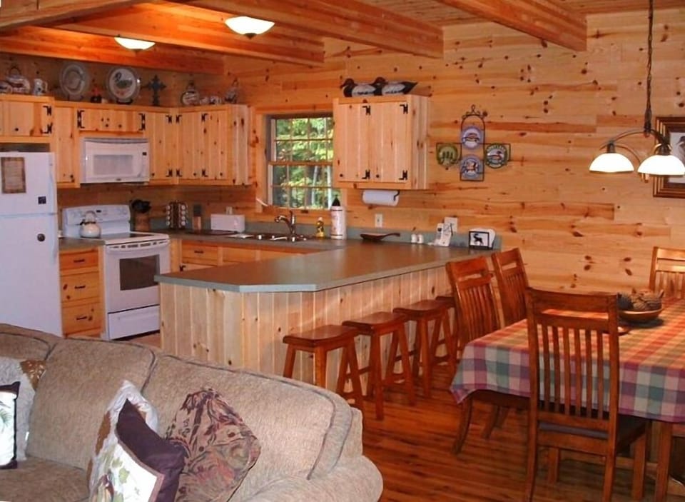Kitchen & Dining Room leading out to covered porch overlooking creek