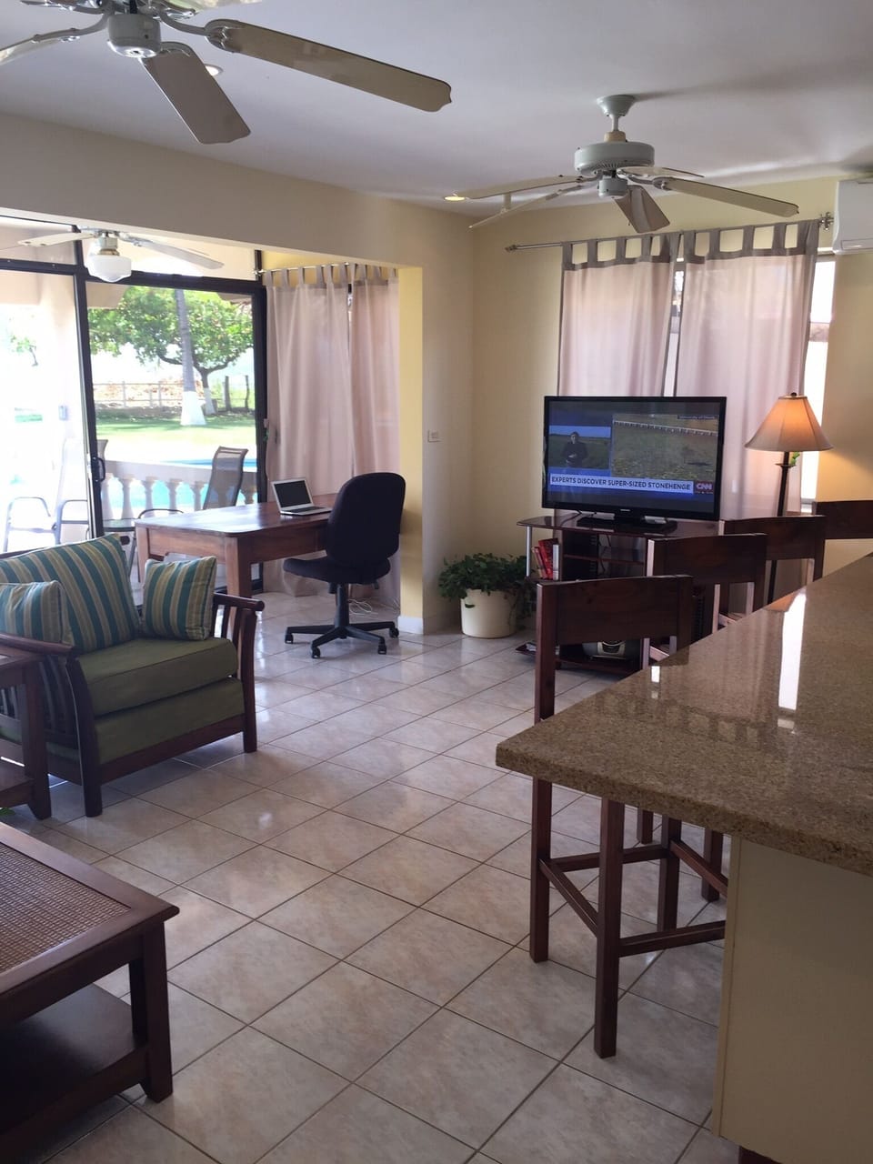 Living room with 40 inch flat screen tv and work desk sofa and to big Chairs 