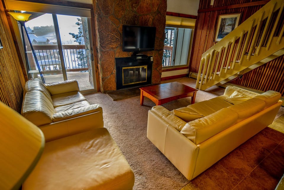 Great room offers comfortable leather seating to relax to a movie or play games