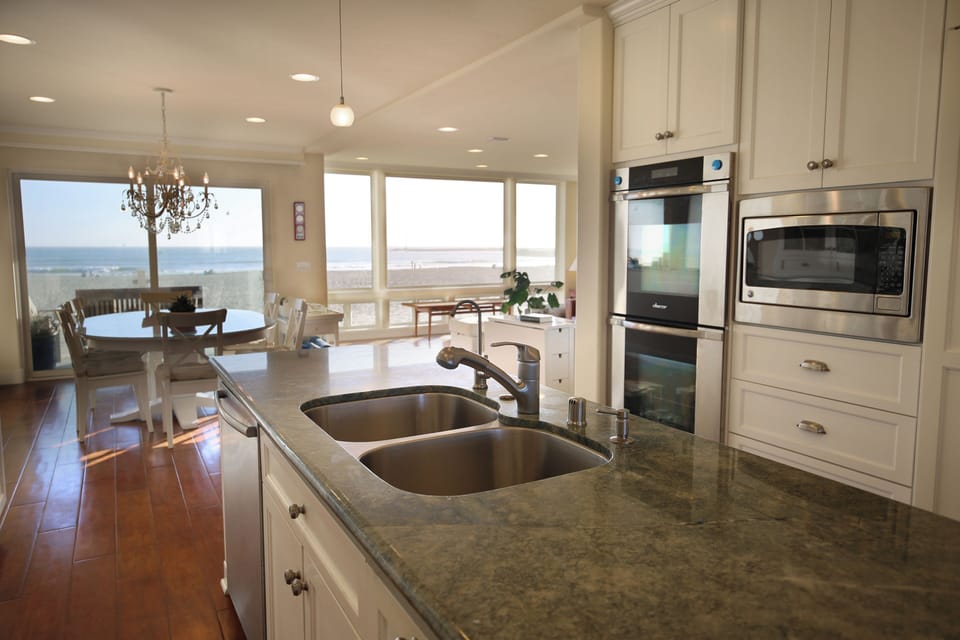 Gas cooktop, double sink, double over, microwave, and dishwasher plus views! 