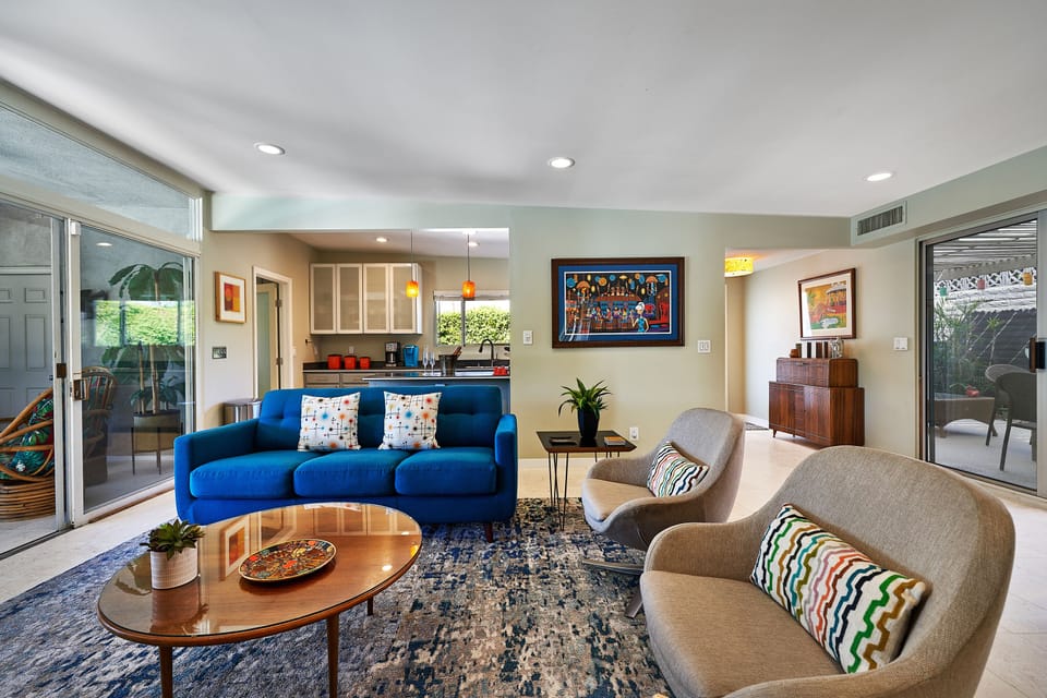 Comfortable living room with mid-century decor and art. Queen sleeper sofa.