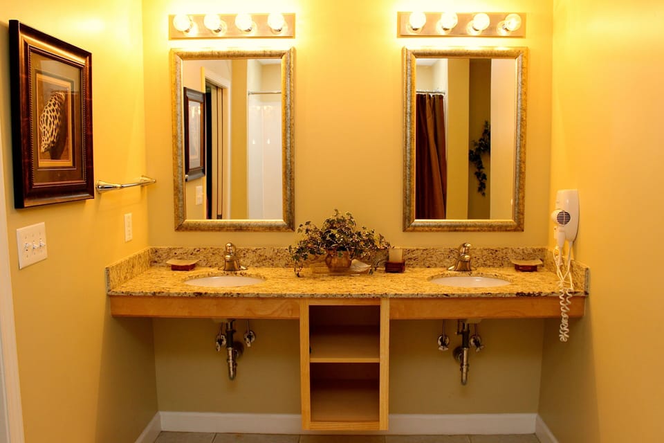 Spacious ensuite bathroom with a dual-sink vanity and bathtub.