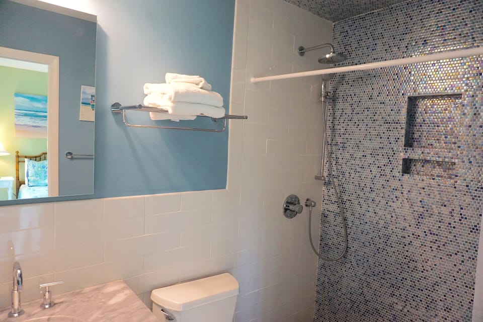 Queen bathroom renovated to feature a beautifully tiled walk-in shower.