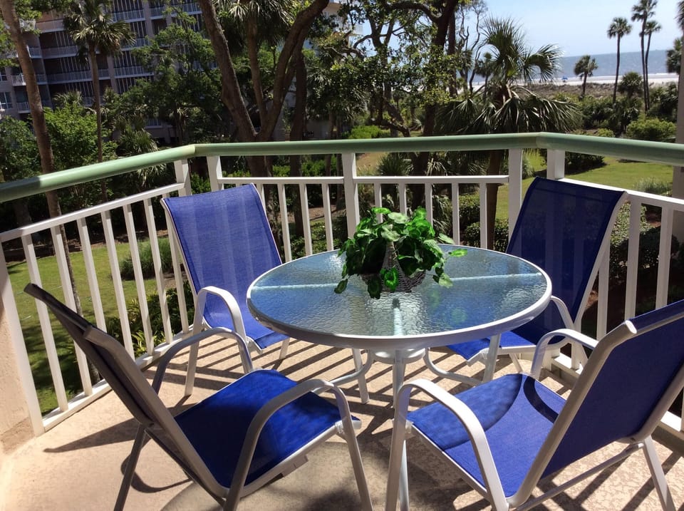 Balcony with 4 chairs and table.  1 chaise  lounge