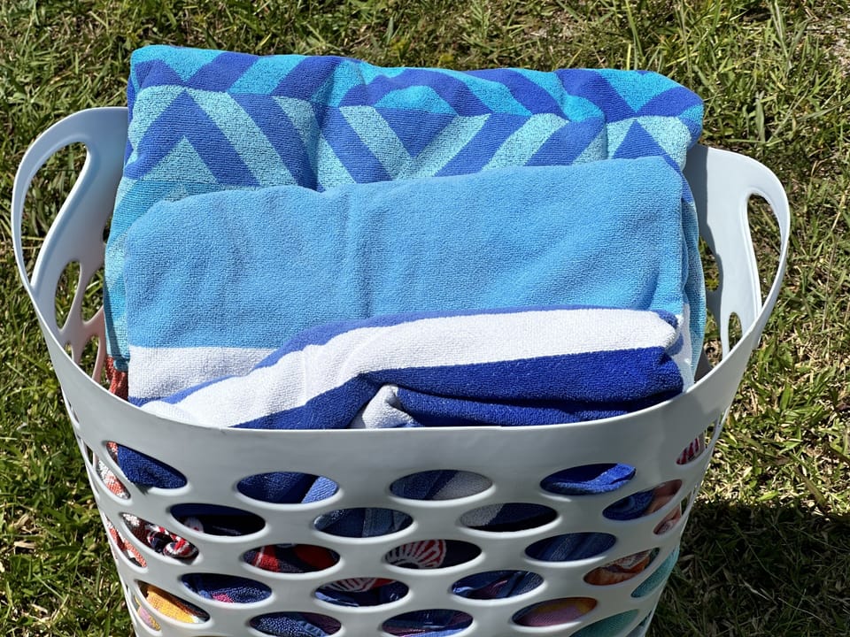 Top quality clean colorful beach towels in abundance at Coral Cottage.