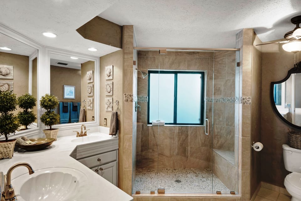 Master bath with walk in shower and glass doors.
