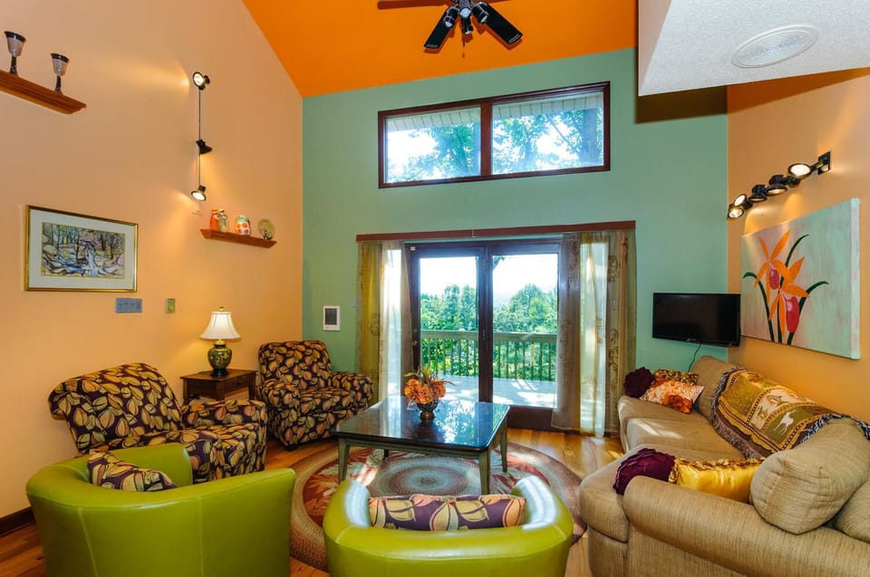 Ground floor living room has plenty of seating and views of mountain sunset.