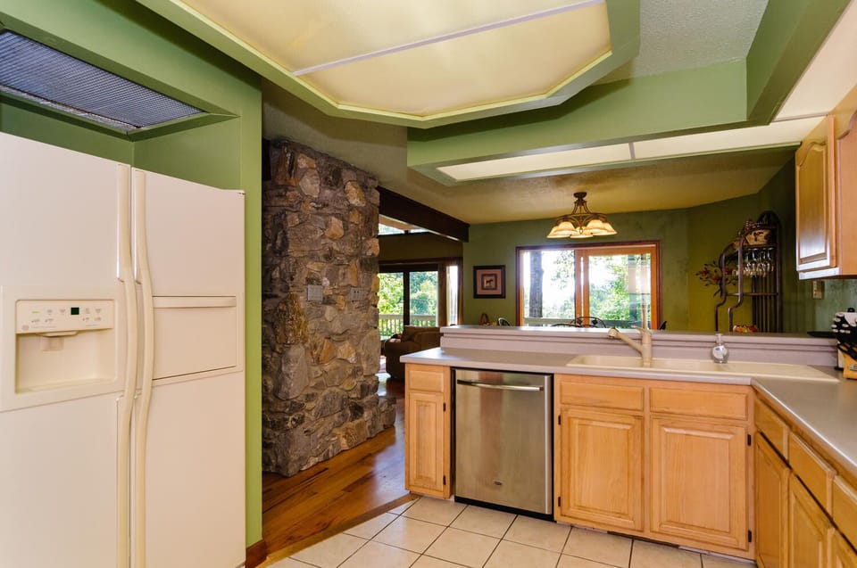 Kitchen convenient to dining room, living room, and deck.