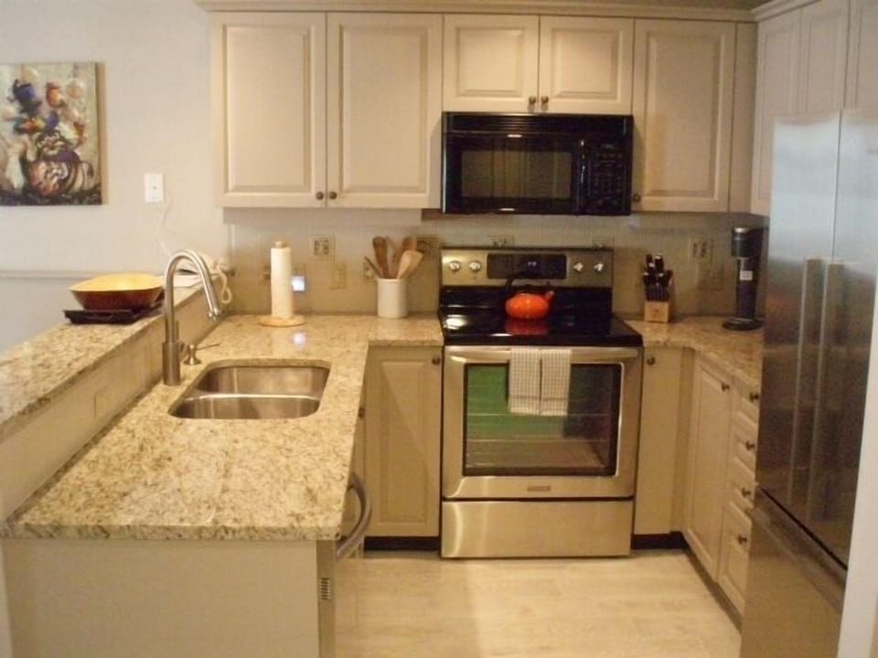 Kitchen with full assortment of cooking utensils
