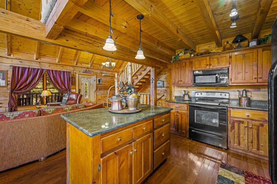 Kitchen with granite counter tops open to the living room. 