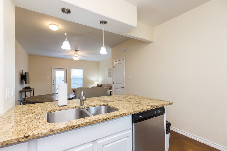 Your open-concept space flows seamlessly from granite kitchen to cozy living room, perfect for relaxing evenings together.
