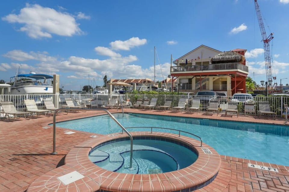 Pool and hot tub overlook the waterway.