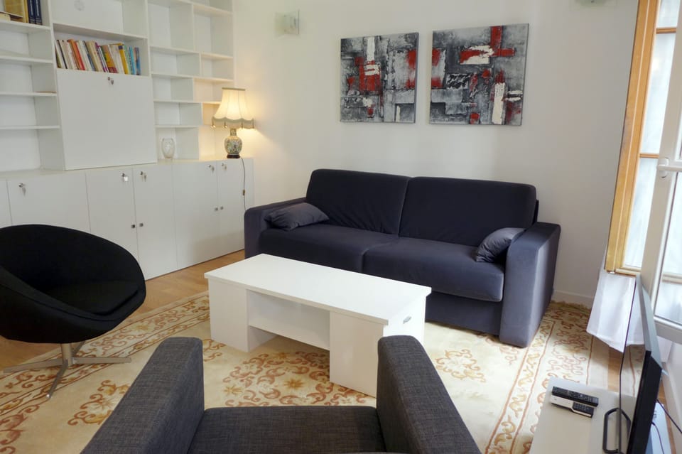 The living room also offers a center table & a wall unit
