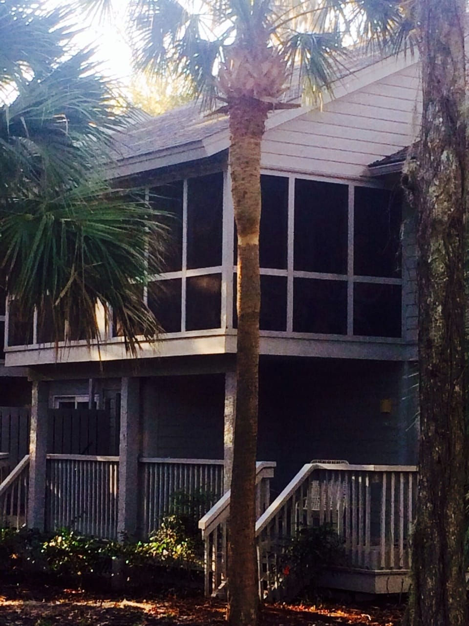 Back of condo. Screen porch on second floor. Deck off of master. 