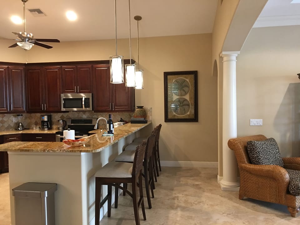 Comfortable seating for four at large granite breakfast bar