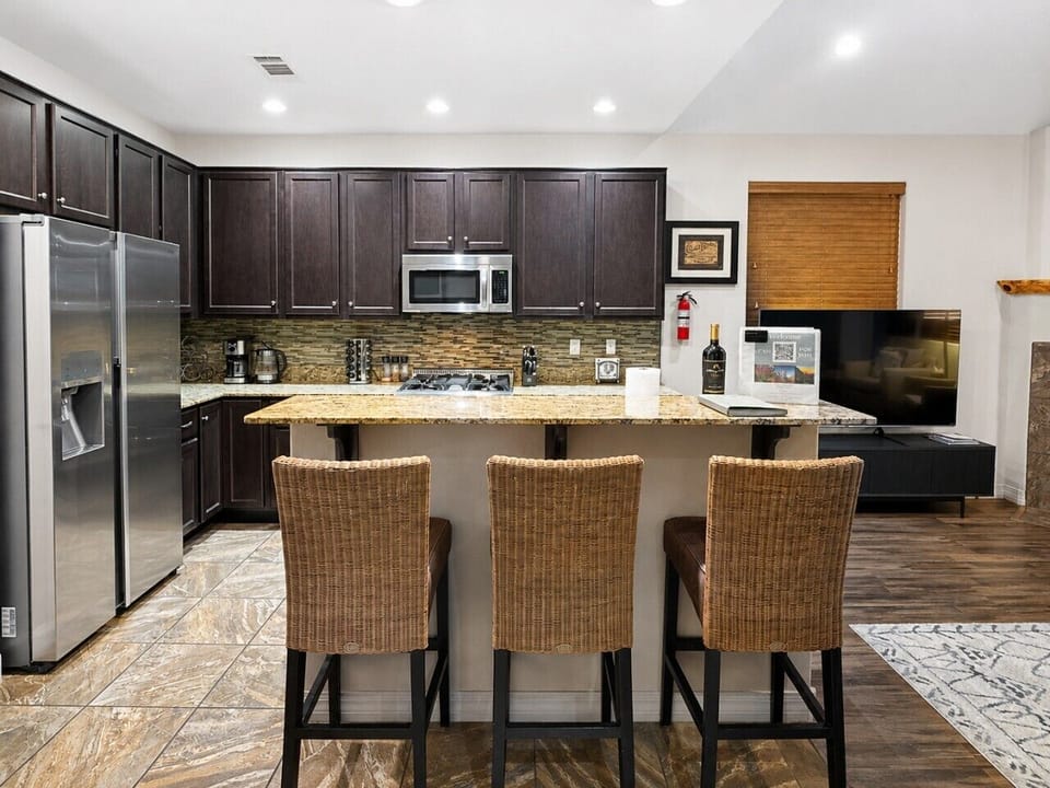 Breakfast bar seating beside the fully stocked kitchen.