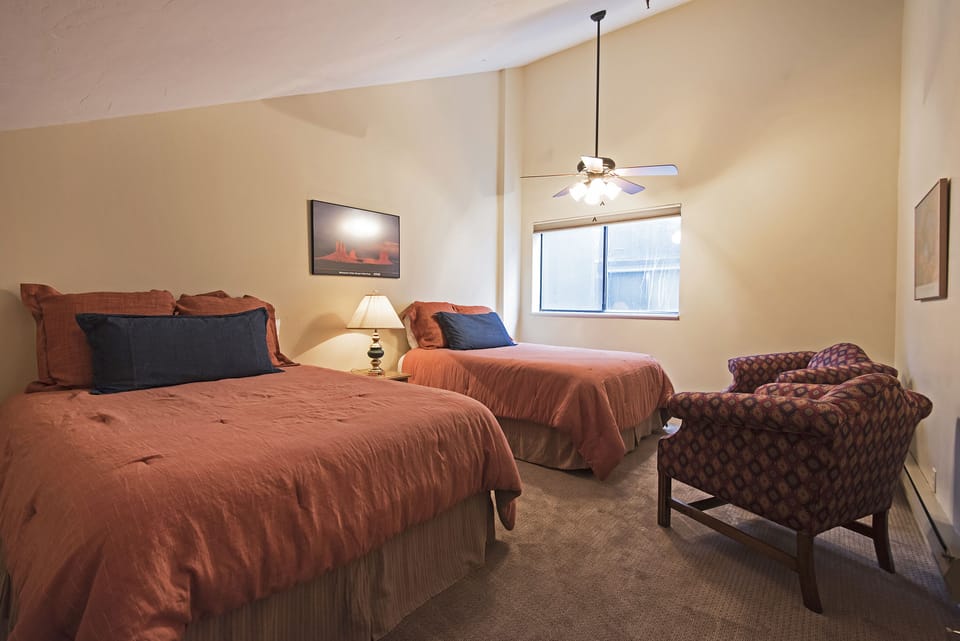 Master bedroom with two queen beds, chair and TV (not shown)