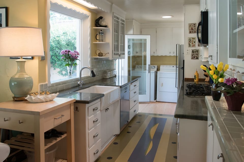 Kitchen with laundry area and door to BBQ patio area