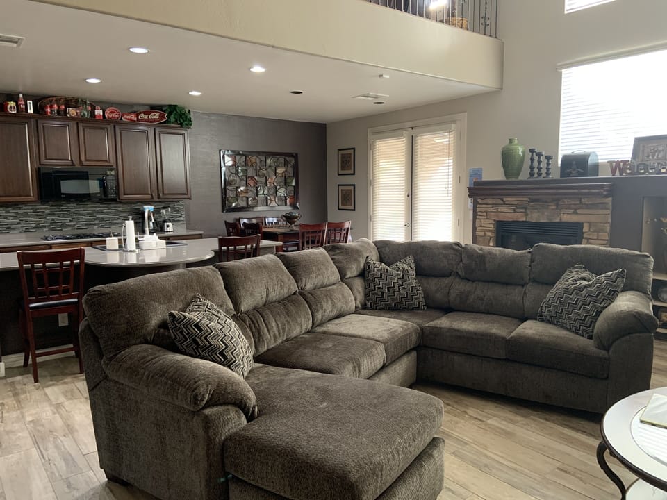 Comfortable living room with 60' TV & natural gas fireplace.
