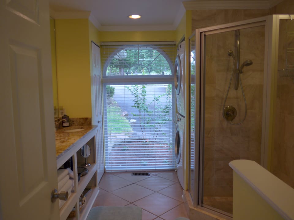 Bathroom with double vanity, standard size shower, no tub
Full size washer/dryer