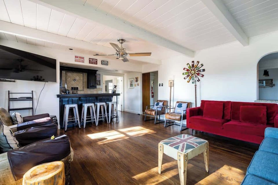 Spacious living room with vibrant seating, bar stools, and plenty of natural light—perfect for relaxing, entertaining, or gathering after a day exploring wine country