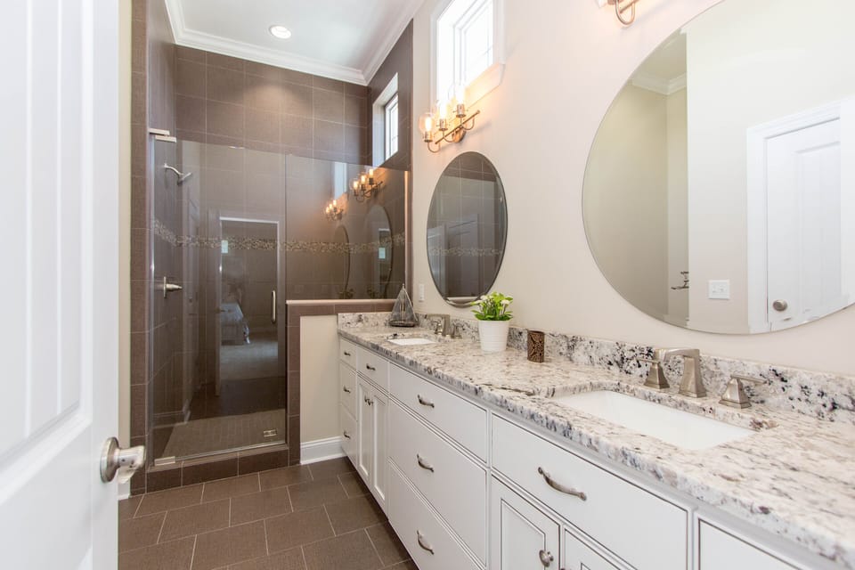 Master Bathroom #1 with dual sinks and granite counters and XL custom shower