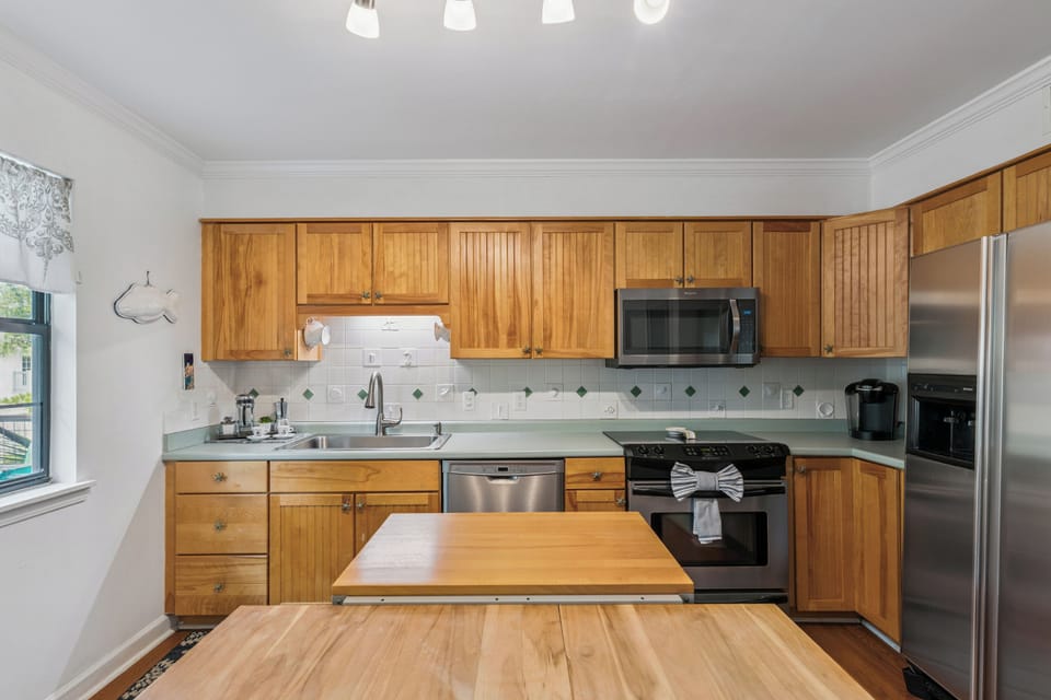 Your fully equipped kitchen features warm wood cabinetry, stainless appliances, and plenty of counter space for preparing meals together during your stay.