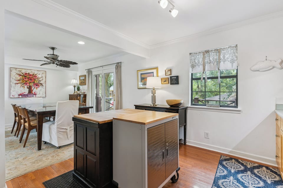 Light-filled open living space with dining area and well-equipped kitchen island ready for your cooking adventures.