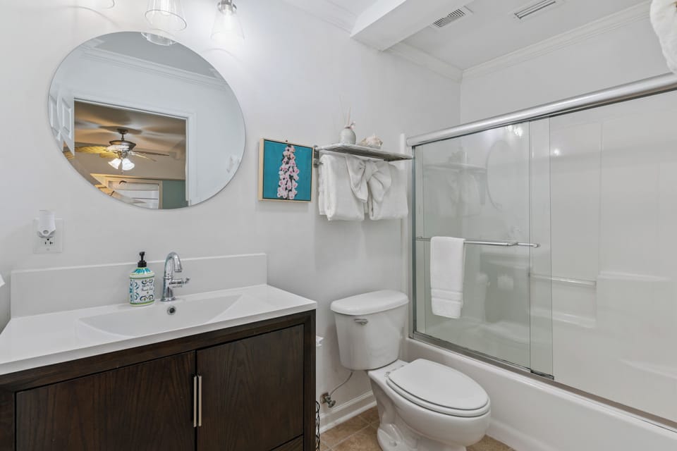 Step into your bright, spotless bathroom with fresh towels waiting, a sleek modern vanity, and a roomy tub-shower combo perfect for unwinding after your adventures.