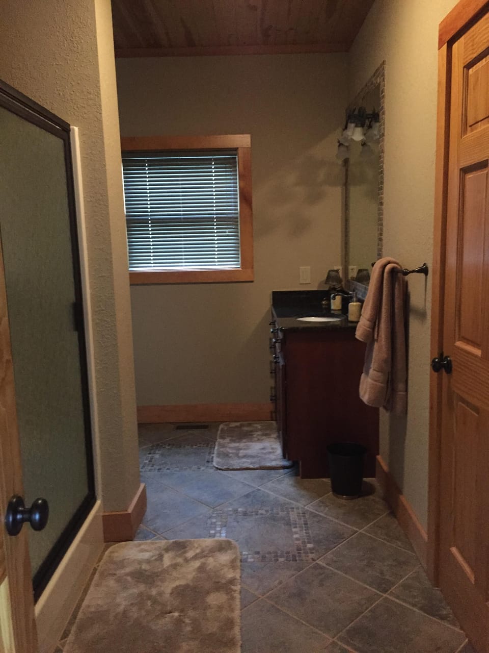 Main floor bathroom with large walk-in shower, connected to bedroom