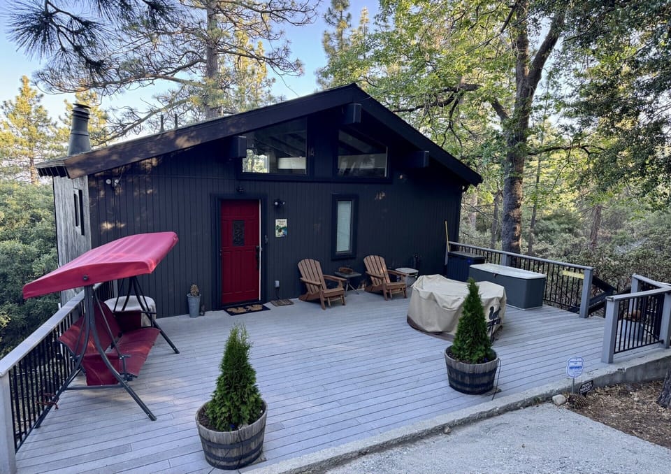 Relax on the deck, swing under the pines and enjoy the serenity of this hideaway