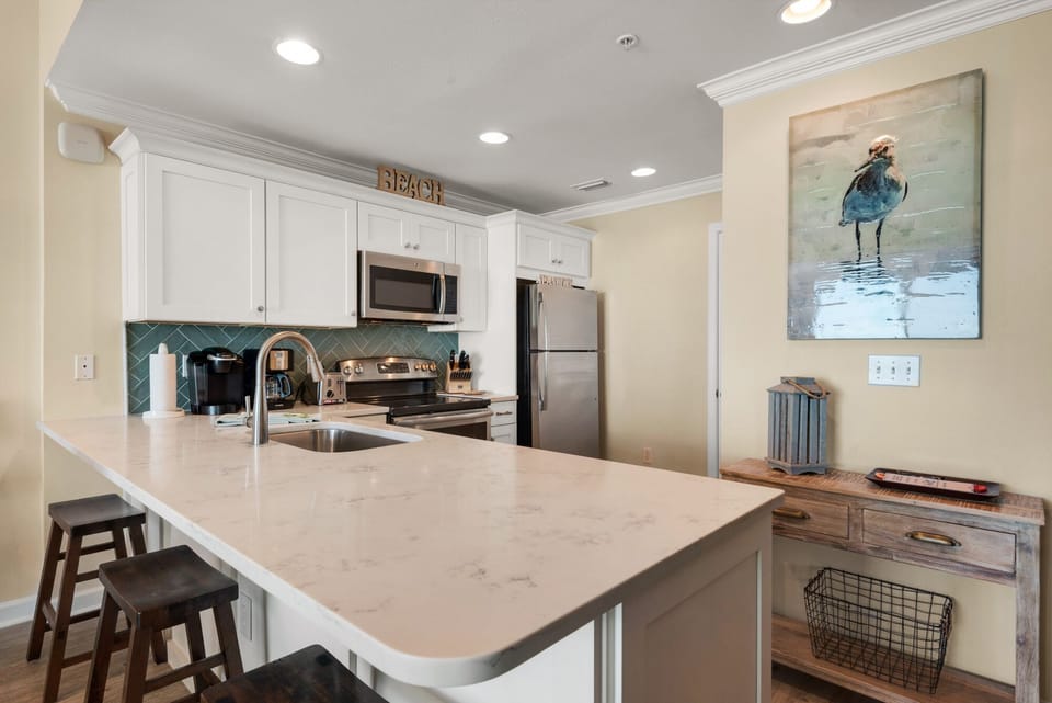 New cabinets, countertops, and appliances  in a kitchen overlooking the gulf