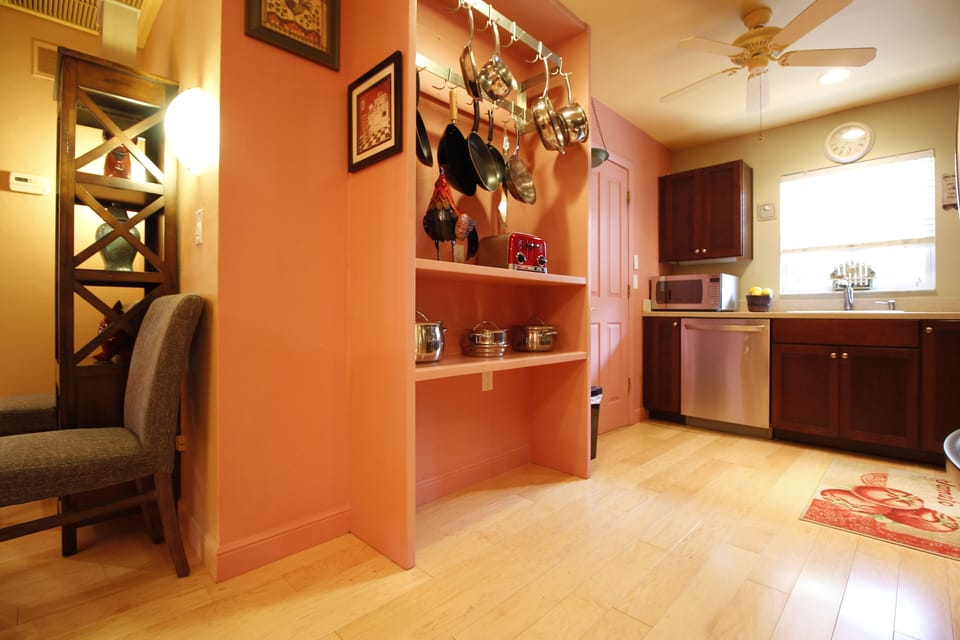 Open kitchen with updated espresso wood cabinets, plenty of quality cookware.