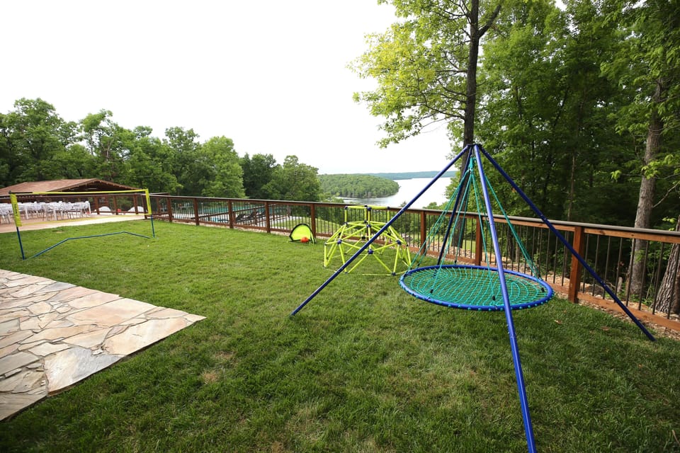 Playground with badminton net, soccer goals, giant swing, climbing frame.