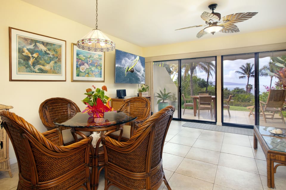 Comfortable dining area that has a view out to the ocean.