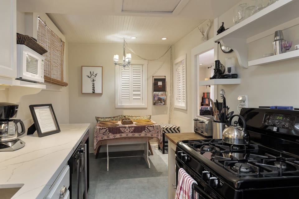 Kitchen and small dining table and banquette area.