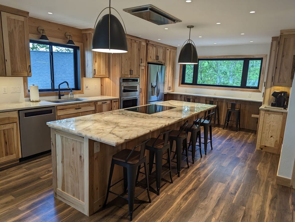 Large eat-in kitchen includes a coffee bar, seating at the island and window bar