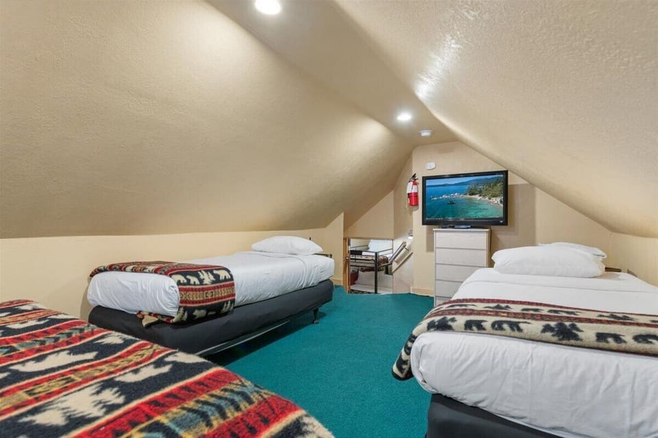 Loft with queen, 2 twins and TV. This is a great spot for families. 