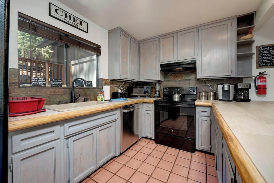 Spacious  kitchen with counter seating. 