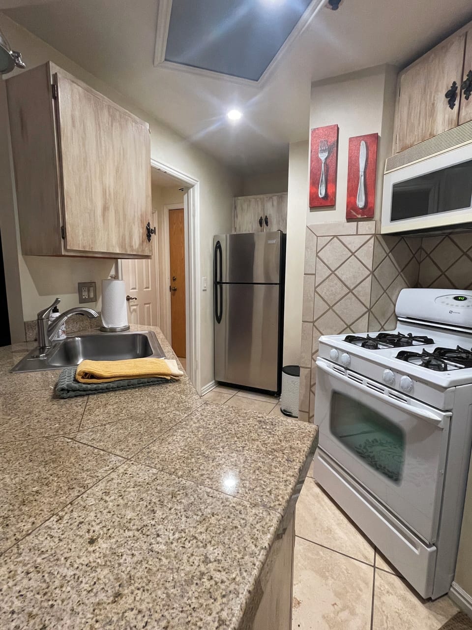 Kitchen, gas stove, microwave, dishwasher, refrigerator.