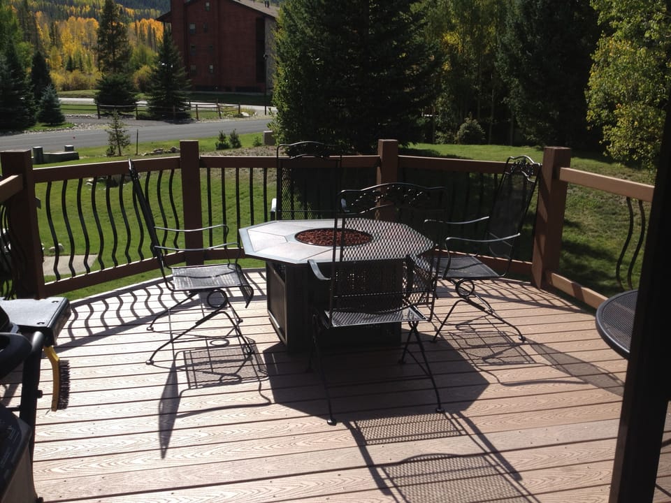 Expanded deck with firepit, table and chairs, bbq and views of Peak One.