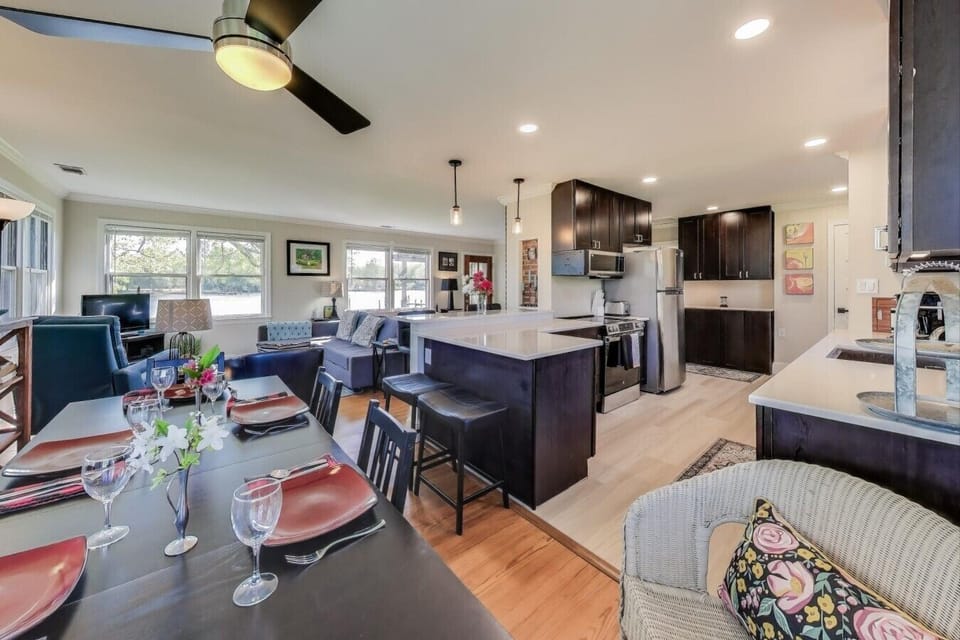 The open kitchen and dining area make it easy to prepare meals, gather around the table, and stay connected.