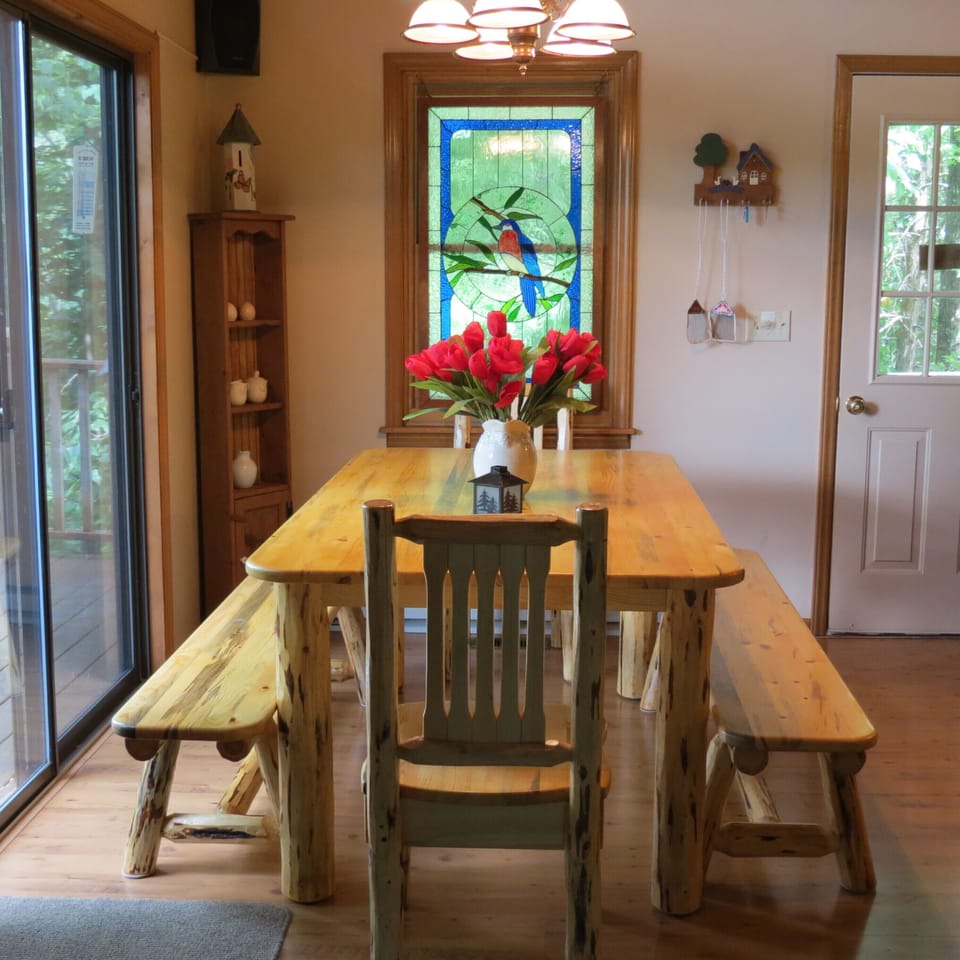 Dining room, rustic log furniture, stained glass accessory, from great room